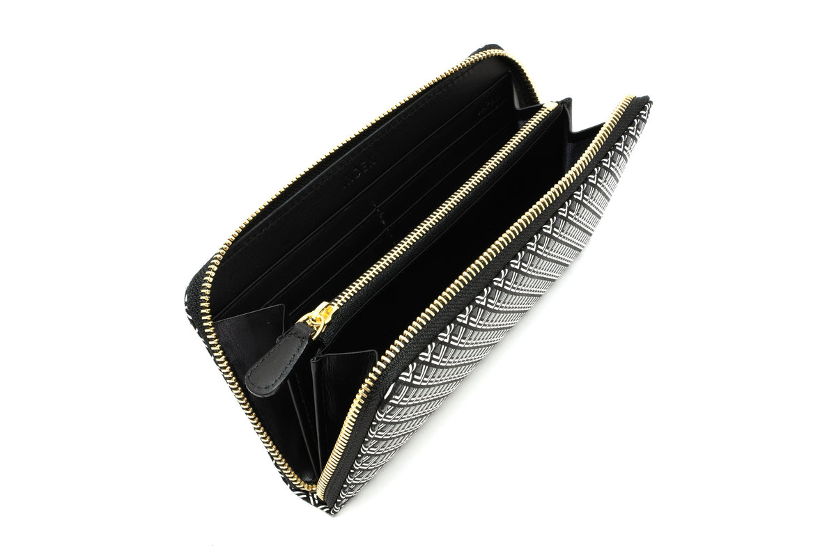 Black and white patterned zippered long wallet with a gold zipper and multiple card slots inside, shown from a top angled view on a white background.