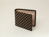 Brown and black checkered pattern wallet partially open showing light beige interior with card slots, viewed at slight angle on plain off-white background.