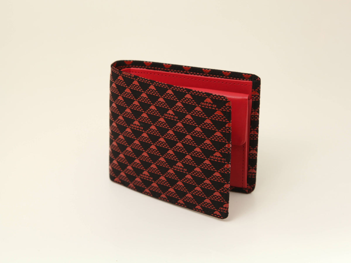 Folded wallet with black and red triangular checkered pattern exterior and vibrant red interior, shown standing open on a light surface.