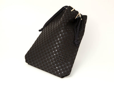 Takane Drawstring Pouch in Black x Black color showing textured lacquered deer leather and cinched drawstring top