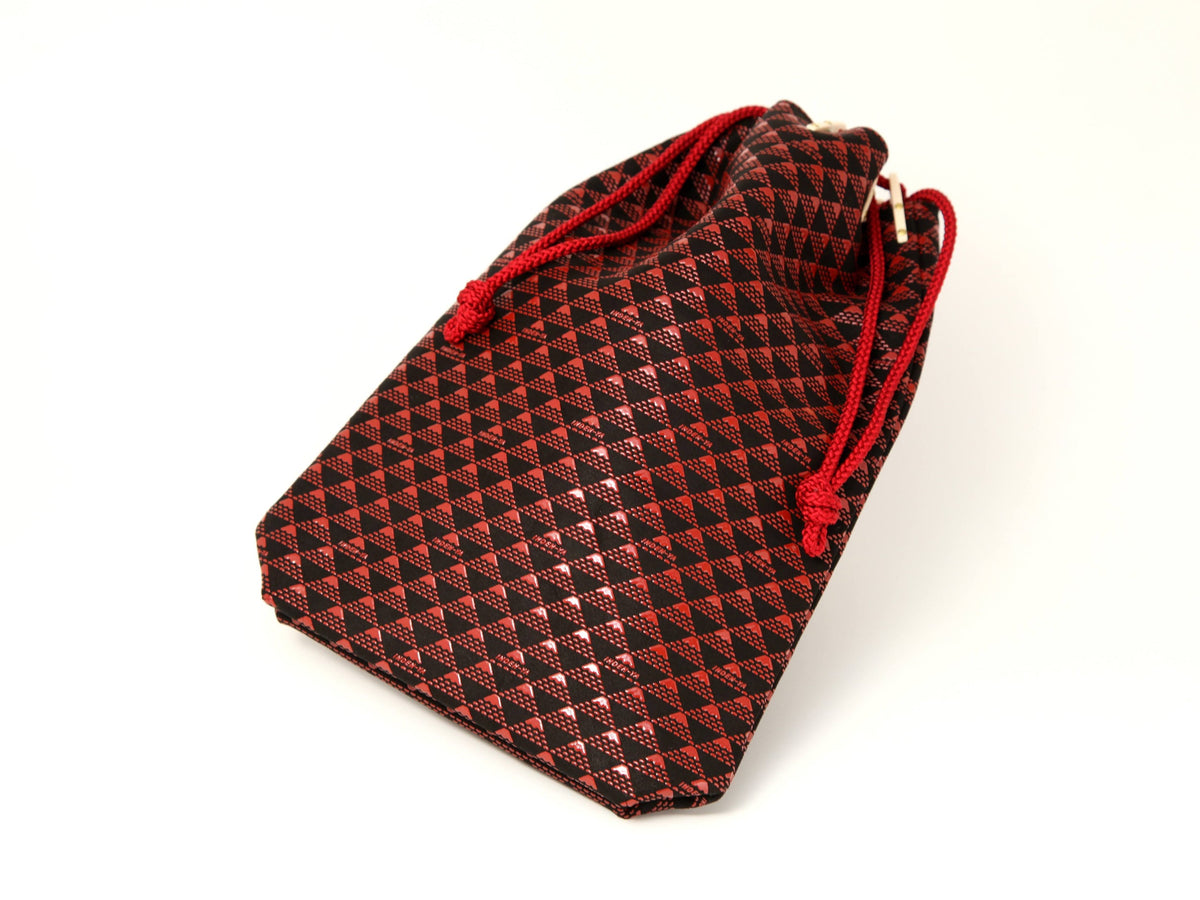 Small drawstring pouch with a black and red triangular geometric pattern and red cords for closure.