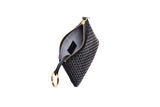 Black large key case with a textured woven pattern, gold zipper, and attached gold key ring, shown open with the interior fabric visible.