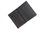 Open business card case featuring a black leather interior and a dark patterned exterior with a diamond geometric design.