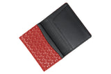 Open business card case featuring a black interior with card slots and a red exterior flap with a geometric diamond pattern in white.