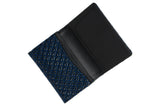 Open business card case with a glossy blue diamond-patterned lower half and smooth black upper half featuring card slots, shown on a white background.