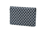 Black and white leather business card case laid on white surface, shown closed and open with cards inside