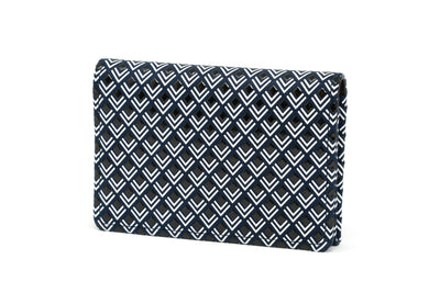 Black and white leather business card case laid on white surface, shown closed and open with cards inside