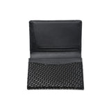 Black leather business card case with chevron pattern, open showing card slots