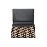 Open black leather business card case with a beige and black geometric chevron pattern on the lower half and the brand name Inden embossed inside.