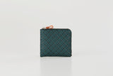 Small square coin purse in dark teal with a diamond lattice pattern and a zipper with an orange pull tab along the top edge.