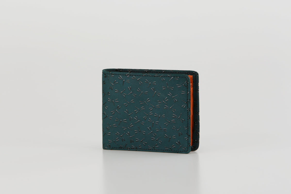 Compact folded wallet with teal exterior embossed with a subtle dragonfly pattern and a contrasting orange interior, shown front-facing on white background.