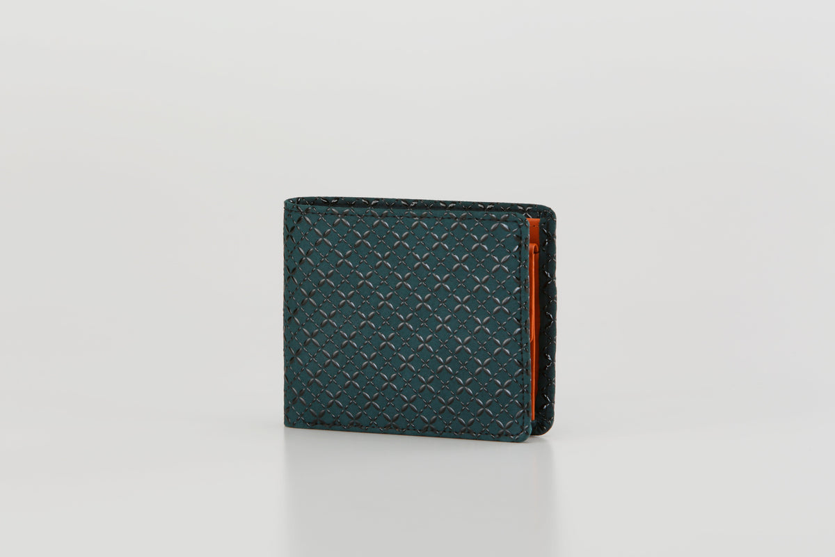 Dark teal folded wallet with a subtle geometric pattern and visible orange interior edge, standing upright against a plain light background.
