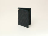 Dark green rectangular pass case with a textured checkerboard pattern on the front and a small metal emblem near the top corner, standing open against a plain background.