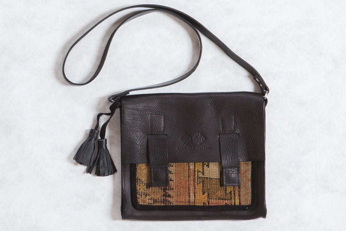 Antique Caucasian Rug Fragment Messenger Bag featuring orange and yellow rug fragment with leather strap and metal zipper