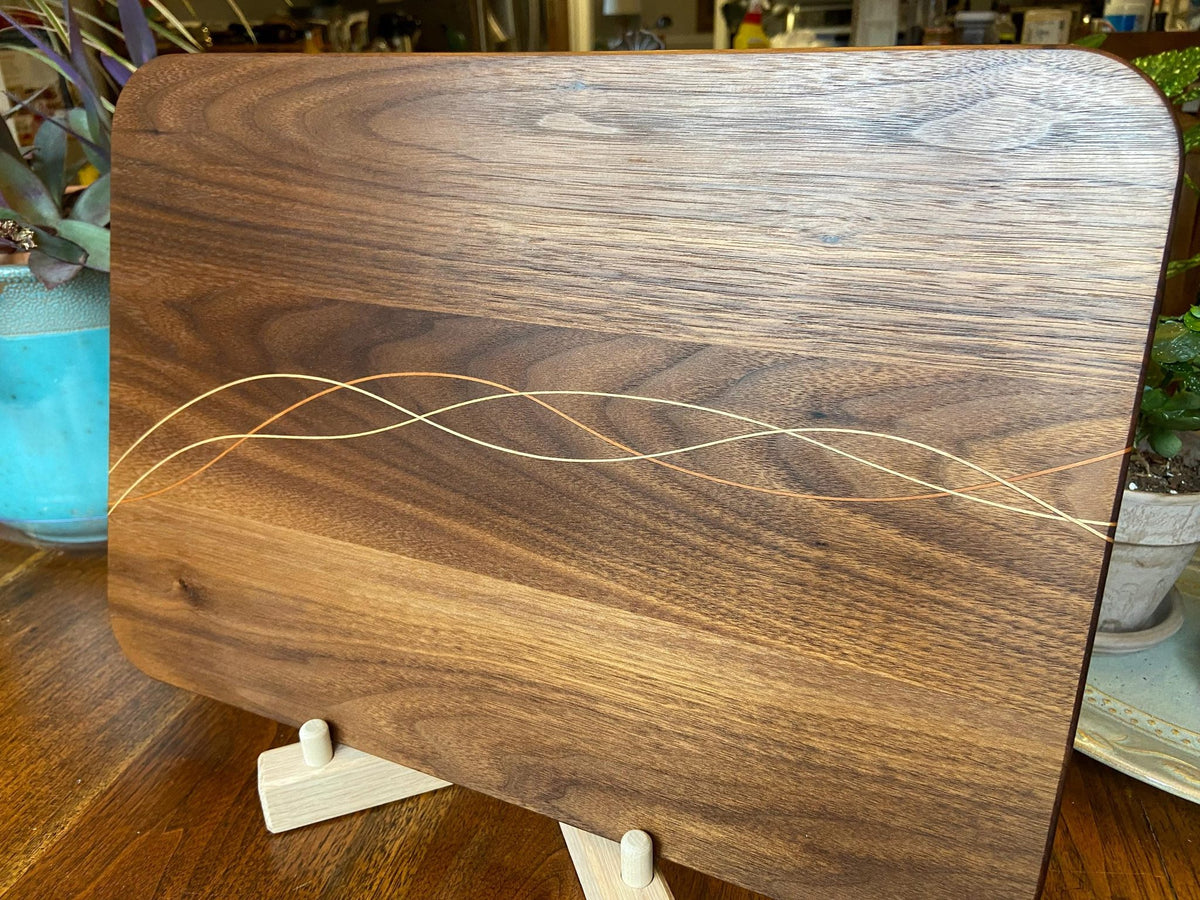 Handcrafted Walnut charcuterie board with Cherry and Maple decorative banding