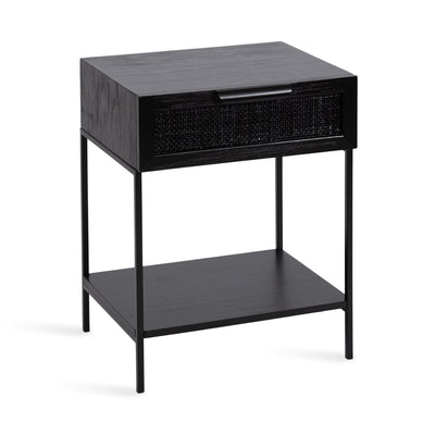 Ori Wood and Cane Side Table in black, featuring a cane rattan pull drawer and a two-tiered design in a modern interior setting.