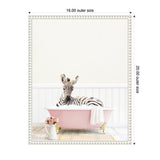 Young zebra reclining in a pink clawfoot bathtub with white bubbles and a towel, wooden floor, white wainscoting, and pink flowers in a white pitcher nearby.