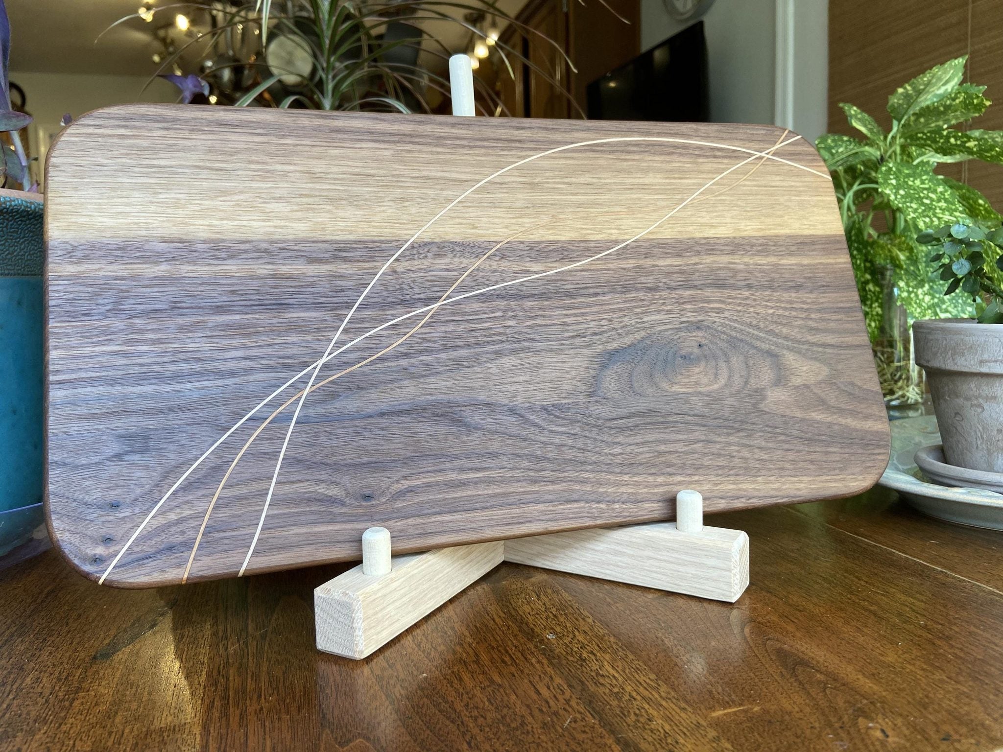 Walnut charcuterie board with cherry and maple decorative banding, handcrafted serving board