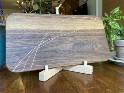 Walnut charcuterie board with cherry and maple decorative banding, handcrafted serving board