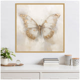 Square framed canvas art of a large butterfly with translucent white wings accented in soft beige and gold tones on a neutral background, hanging above a white dresser with plants and books.