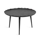 Round black metal coffee table with a scalloped edge tray top and three tapered legs, shown against a white background.