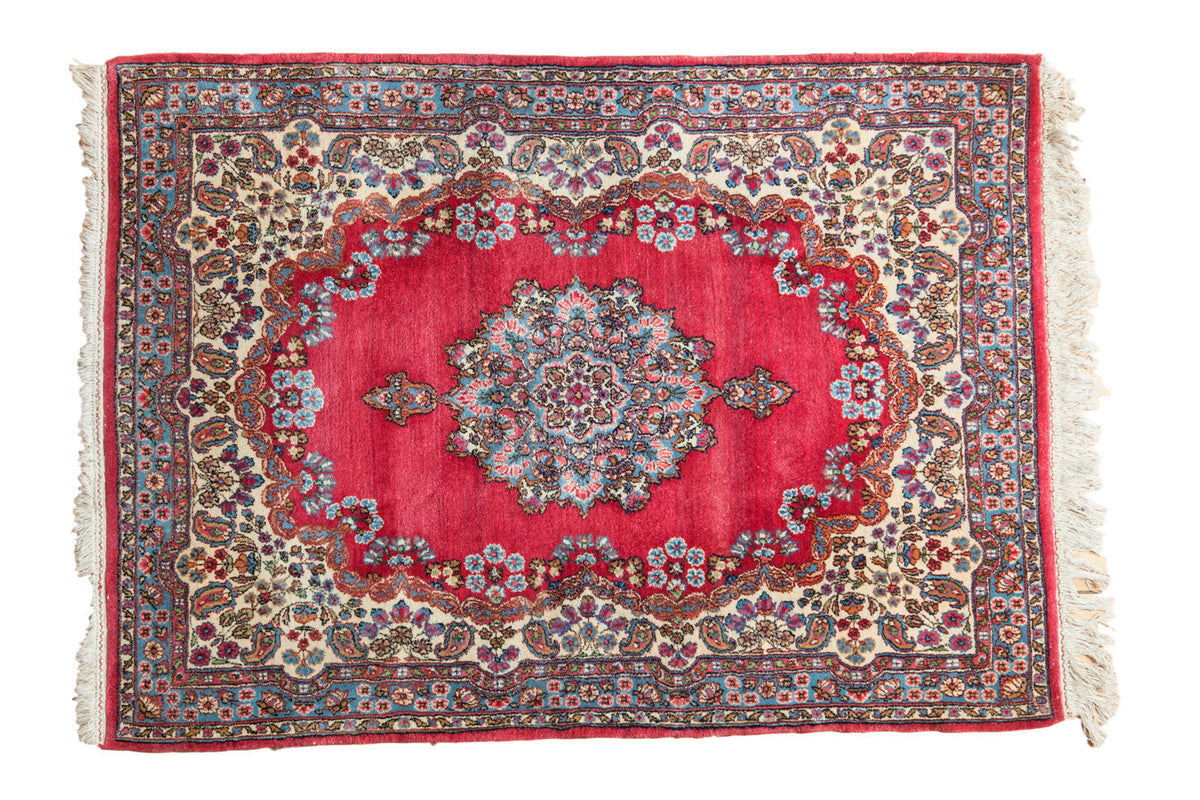 4x5.5 Vintage Kerman Rug laid flat showing roundel medallion and floral patterns in rich cochineal red and complementary colors.