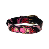 Dog collar with fuchsia, light pink, and red snake pattern on black background featuring custom gold buckle and D-ring hardware.