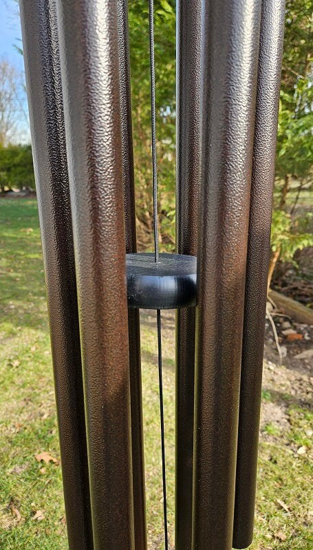 Amish handmade aluminum wind chimes in various sizes hanging outdoors