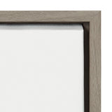 Close-up of the corner of a white canvas stretched over a wooden frame with light brown grain and smooth texture, viewed from the side.