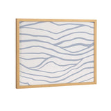Rectangular wall art with gentle, wavy light blue lines across a white background in a simple natural wood frame, evoking a coastal wave pattern.