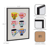 Framed print featuring six colorful, patterned coffee and tea cups arranged in two vertical columns on a light background with a black minimalist wood frame.