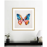 Framed artwork of a butterfly with bold brush strokes in blue, orange, pink, and yellow hues against a light background above a black shelf with plants, books, and a lamp.
