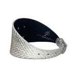 Silver snake-patterned leather bracelet with a tapered design and a metal buckle, shown with the interior black lining and brand logo visible.