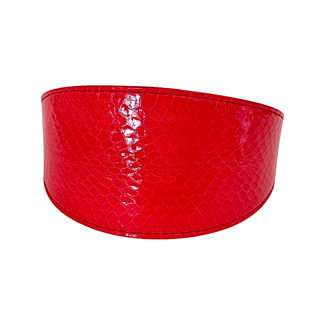 Wide collar in glossy red-orange snake pattern leather with subtle scale texture and curved shape, shown against a white background.