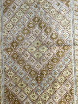 Square hand-knotted Afghani Nakhunak wool rug with repeated diamond motifs in beige, brown, and pale blue tones, framed by a thin geometric border.