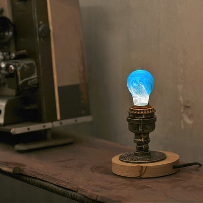 EP Light Memory Resin LED Bulb handcrafted with eco-friendly resin, shown with wooden base options