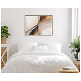 Abstract wall art above bed with soft beige, brown, and white tones featuring fluid, layered textures and a framed canvas in a bright minimalist bedroom.