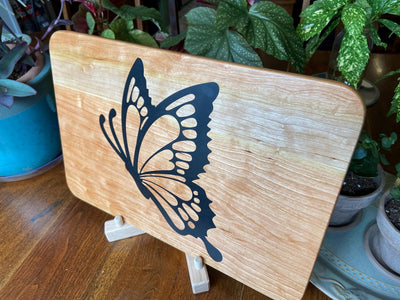 Cherry wood charcuterie board with butterfly-shaped resin inlay