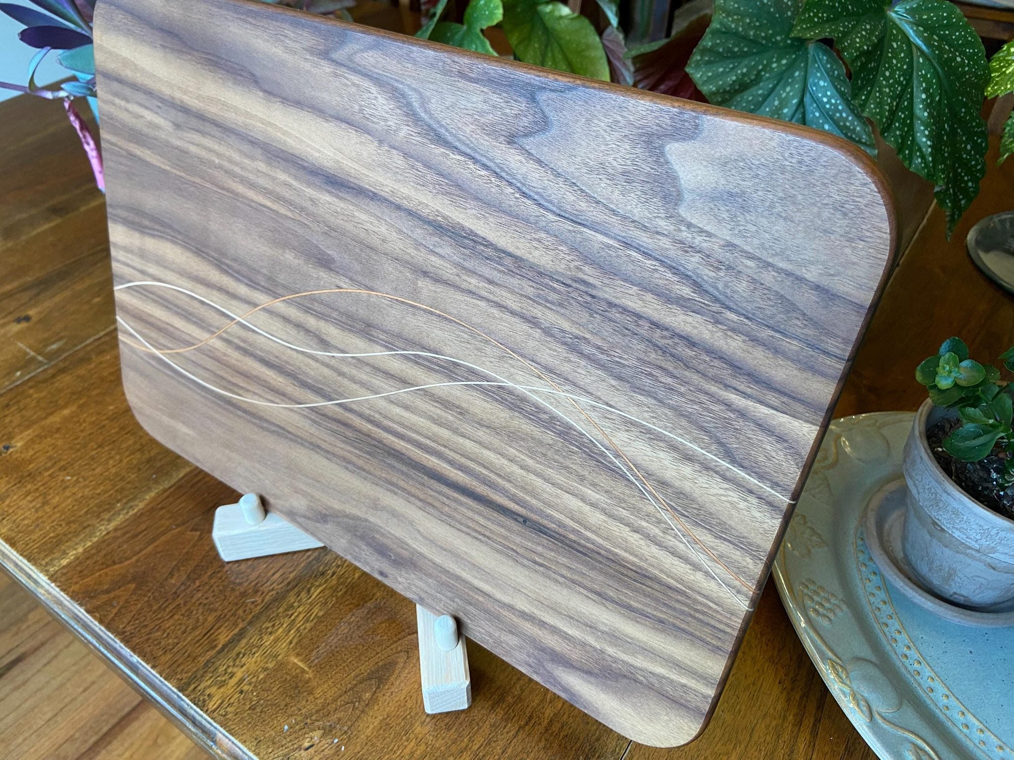 Walnut charcuterie board with cherry and maple decorative banding by Fitzgerald Custom Woodcraft