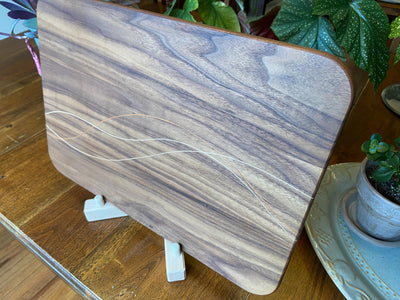 Walnut charcuterie board with cherry and maple decorative banding by Fitzgerald Custom Woodcraft