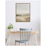 Softly blurred landscape painting in muted beige and gray tones framed above a minimalist wooden desk with a light blue chair and a small potted plant.