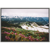 Framed canvas showing a mountain landscape with snow patches and wildflowers in the foreground under a cloudy sky, by Patricia Hasz.