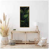 A framed aerial photograph depicting a winding dark river cutting through a lush green valley, hanging above a rustic wooden console table with neutral decor.