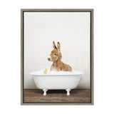 Illustration of a brown baby donkey sitting in a white clawfoot bathtub filled with bubbly foam, accompanied by a small yellow duckling on the foam's edge against a plain white background.