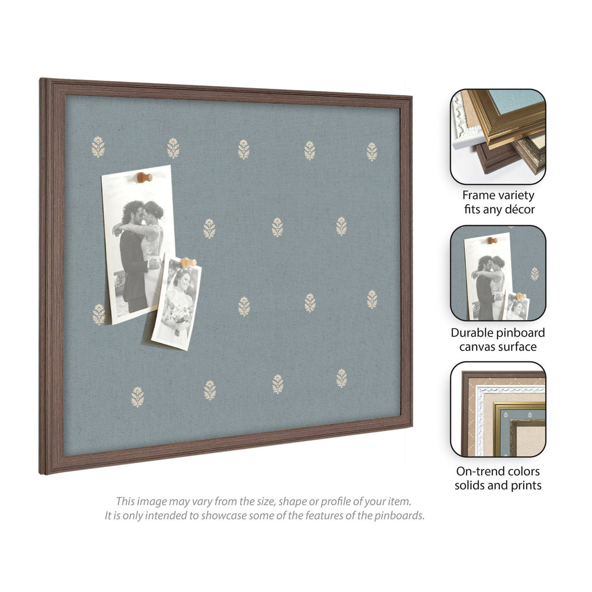 Rectangular pinboard with blue fabric featuring a small repeating white botanical pattern and a dark wooden frame, displaying two monochrome photo prints secured by clips.