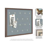 Rectangular pinboard with light blue fabric featuring a subtle white botanical print, framed in medium brown wood, displaying two black-and-white pinned photos.