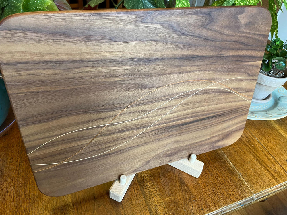 Walnut charcuterie board with cherry and maple decorative banding by Fitzgerald Custom Woodcraft
