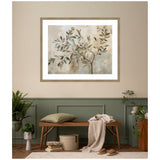 Framed abstract wall art of olive tree branches with muted green and brown leaves on a beige and gray background, hanging above a wooden bench in a minimalist room.