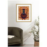 Framed wall art depicting a stylized vessel in dark blue with orange floral and geometric accents on a beige background, hanging above an olive green chair and beside a potted olive tree.