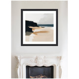 Abstract coastal landscape with beige sand, dark cliff silhouette on left, soft blue ocean horizon, and muted gray sky, framed in black on a white wall above ornate white mantel.